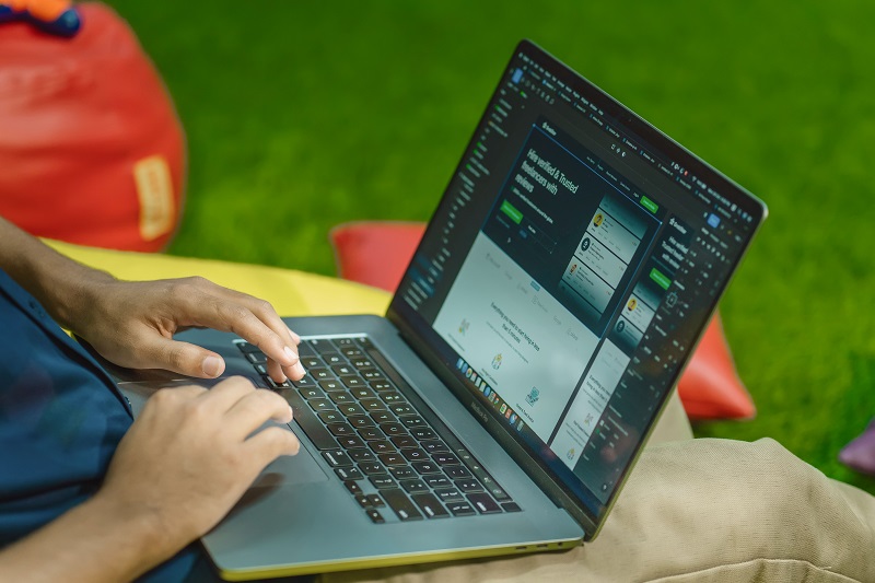 Person reviewing a WordPress website on a laptop during a plugin performance audit